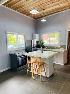 a kitchen with a table and a stove top oven at Lizard King Hotel & Suites in Puerto Viejo