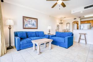 a living room with two blue couches and a table at Fourth level views at Blue Heron Beach Resort in Orlando