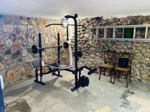 a room with a gym with a stone wall at Fantastic Anfi Tauro Duplex with ocean view in Las Palmas de Gran Canaria