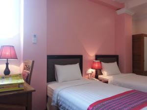 A bed or beds in a room at Grand Laurel Hotel