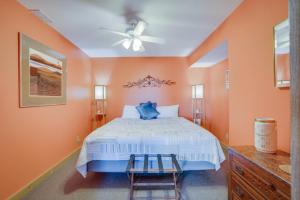 a bedroom with a bed and a ceiling fan at Lake Breeze Timber in Lake Ozark +36 photos