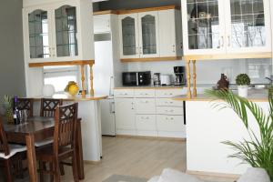 cocina con armarios blancos y mesa de madera en 2Room apartment in Amazing place, Free parking, en Oulu