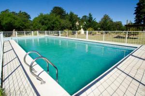a swimming pool with a fence around it at Ecoparque Kooch in Sierra de la Ventana
