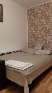 una cama en una habitación con una pared de ladrillo en Studio Timpuri Noi 50, en Bucarest