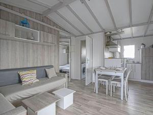 a living room with a couch and a table at Comfort in Grandcamp-Maisy in Grandcamp-Maisy