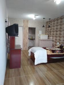 Un pat sau paturi într-o cameră la Recanto das Videiras