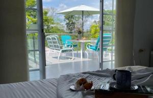 a bedroom with a bed with a table and chairs at Casa Merchu Finca Spa in Puerto Espejo