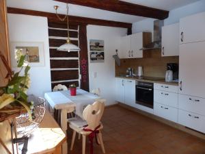 a kitchen with a table and a dining room at Landhaus Krappinger in Bad Kleinkirchheim