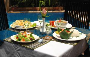 a table with plates of food on top of it at Tan Kang Angkor Hotel in Siem Reap