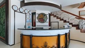 a room with a counter with clocks on the wall at RedDoorz Premium @ Nick Hotel Gerona Tarlac in Tarlac