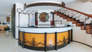 a spiral staircase in a living room with a stair case at RedDoorz Premium @ Nick Hotel Gerona Tarlac in Tarlac