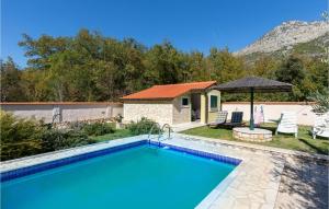 a swimming pool in front of a house at Lovely Home In Desne With Kitchen in Rogotin