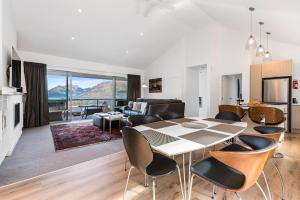 a kitchen and living room with a table and chairs at Skye Horizons in Queenstown