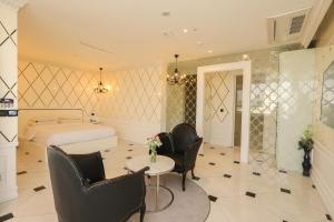 a bedroom with a bed and a table and chairs at Hotel The Designers Hongdae in Seoul