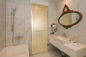 a bathroom with a sink and a shower and a mirror at Hotel The Designers Hongdae in Seoul