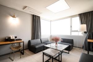 a living room with a couch and a table at Hotel The Designers Hongdae in Seoul