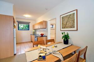 a dining room and kitchen with a table and chairs at Lorne Surf Apartments in Lorne