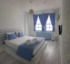 a bedroom with a bed with towels on it at Thea Butik Hotel & Restaurant in Siğacık