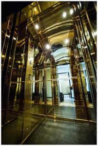 a hallway of a building with a glass doorway at IRIS Hotel in Chişinău