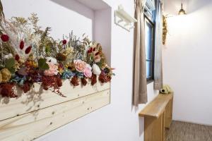 a bunch of flowers on a wall in a room at Anping OAOA Homestay in Anping