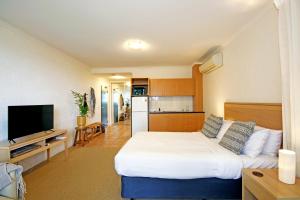 A bed or beds in a room at Lorne Surf Apartments