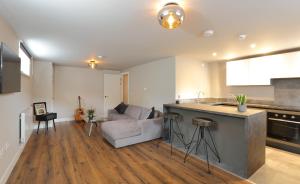 a kitchen and living room with a couch and a table at Declaration Suite in Rhyl