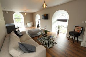 a living room with a couch and two chairs at The Poppy Fields Abode in Rhyl