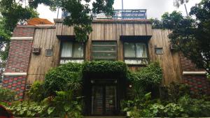 a wooden building with a door in front of it at Cabins by Eco Hotel Tagaytay in Tagaytay