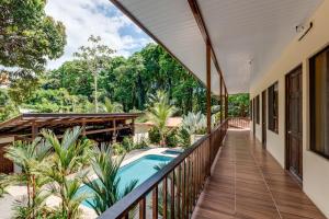 a balcony of a house with a swimming pool at Tropical Beach in Uvita