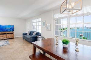 a living room with a table and a couch at NEW Beach Condo 5 min walk to the Beach Sleeps 9 in Clearwater Beach