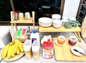 a table with plates and bananas and other ingredients at Early Bird Hostel Ayutthaya in Phra Nakhon Si Ayutthaya