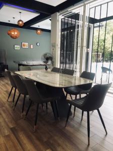 a dining room table and chairs in a room at Maxxim Rainforest Retreat - Rawang in Rawang