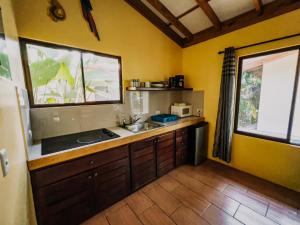 a kitchen with a sink and a counter top at Tropical Beach in Uvita