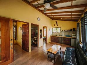 a living room filled with furniture and a kitchen at Tropical Beach in Uvita