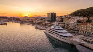 a large yacht is docked in a harbor at sunset at Apartments Mana - 250 m from sea in Split
