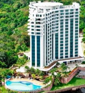 an aerial view of a tall building with a pool at Tropical Executive Flat Vista da Orla in Manaus