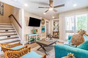 a living room with a blue couch and a tv at Lido Beach Respite in Sarasota