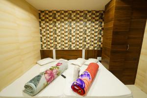 two pillows on a bed in a room at Hotel New Sundaram 150 Mtrs from Dargah in Ajmer +64 photos