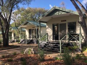 a small white house with a porch at Tasman Holiday Parks - Yallingup Caves in Yallingup