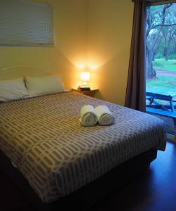 a bedroom with a bed with two towels on it at Tasman Holiday Parks - Yallingup Caves in Yallingup