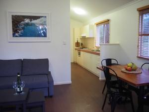 a living room with a couch and a dining room table at Tasman Holiday Parks - Yallingup Caves in Yallingup