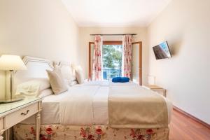 Un ou plusieurs lits dans un hébergement de l'établissement Hotel Cala Fornells