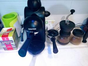 a kitchen counter with a coffee maker and other kitchen items at GORGEOUS FlatB Central London Liverpool St Station in London