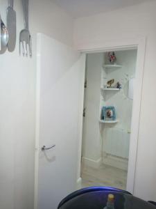 a room with a white door and a room with a shelf at GORGEOUS FlatB Central London Liverpool St Station in London