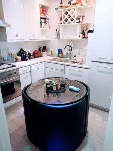 a kitchen with a table in the middle of a kitchen at GORGEOUS FlatB Central London Liverpool St Station in London