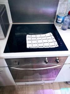 a stove top with a keyboard on top of it at GORGEOUS FlatB Central London Liverpool St Station in London