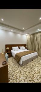 a large bedroom with a large bed in it at سويت ان العلا للشقق المفروشة الخاصة Sweet In alula Apartments and organizing tours in AlUla