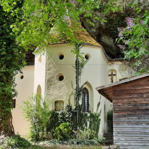 a small white house with a roof at Ferienwohnung Familie Bauer in Kelheim +11 photos