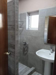 a bathroom with a sink and a shower with a sink at Ledakis Studios in Frangokastello