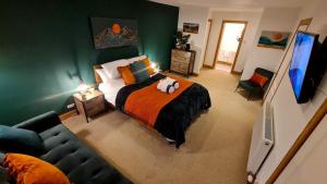 a bedroom with a bed with a stuffed animal on it at Acarsaid B&B in Lybster